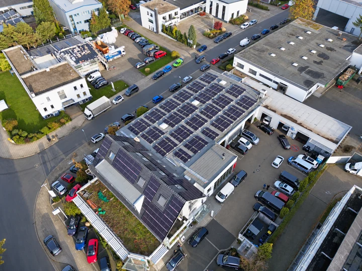 Drohnenansicht einer Solaranlage auf mehreren Dachflächen eines Gewerbebetriebs