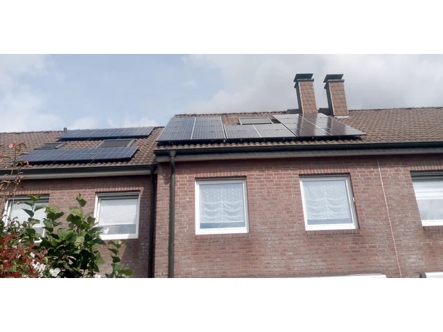 Reihenhäuser mit roter Klinkerfassade, schwarze Solarmodule auf den Dachflächen